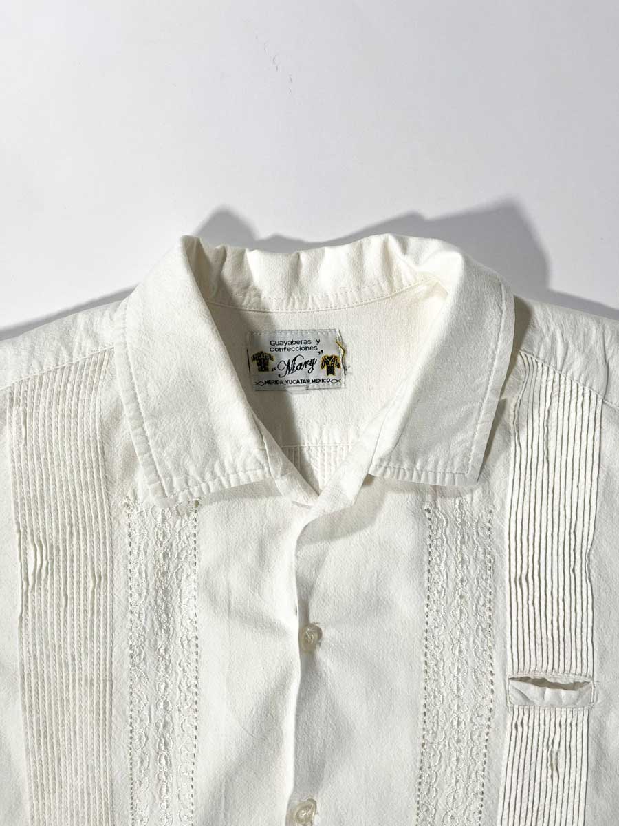 Handcrafted guayabera shirt made in Merida, Mexico. Embroidery done down to the smallest details and with extremely high quality fabric. Vintage product. Positioned on a neutral white background.