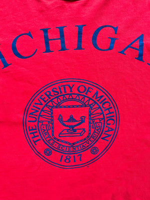 University of Michigan single stitch tee. Made in the United States in 1980. Bright red color with orange sleeves. Rare vintage piece. Quality cotton.