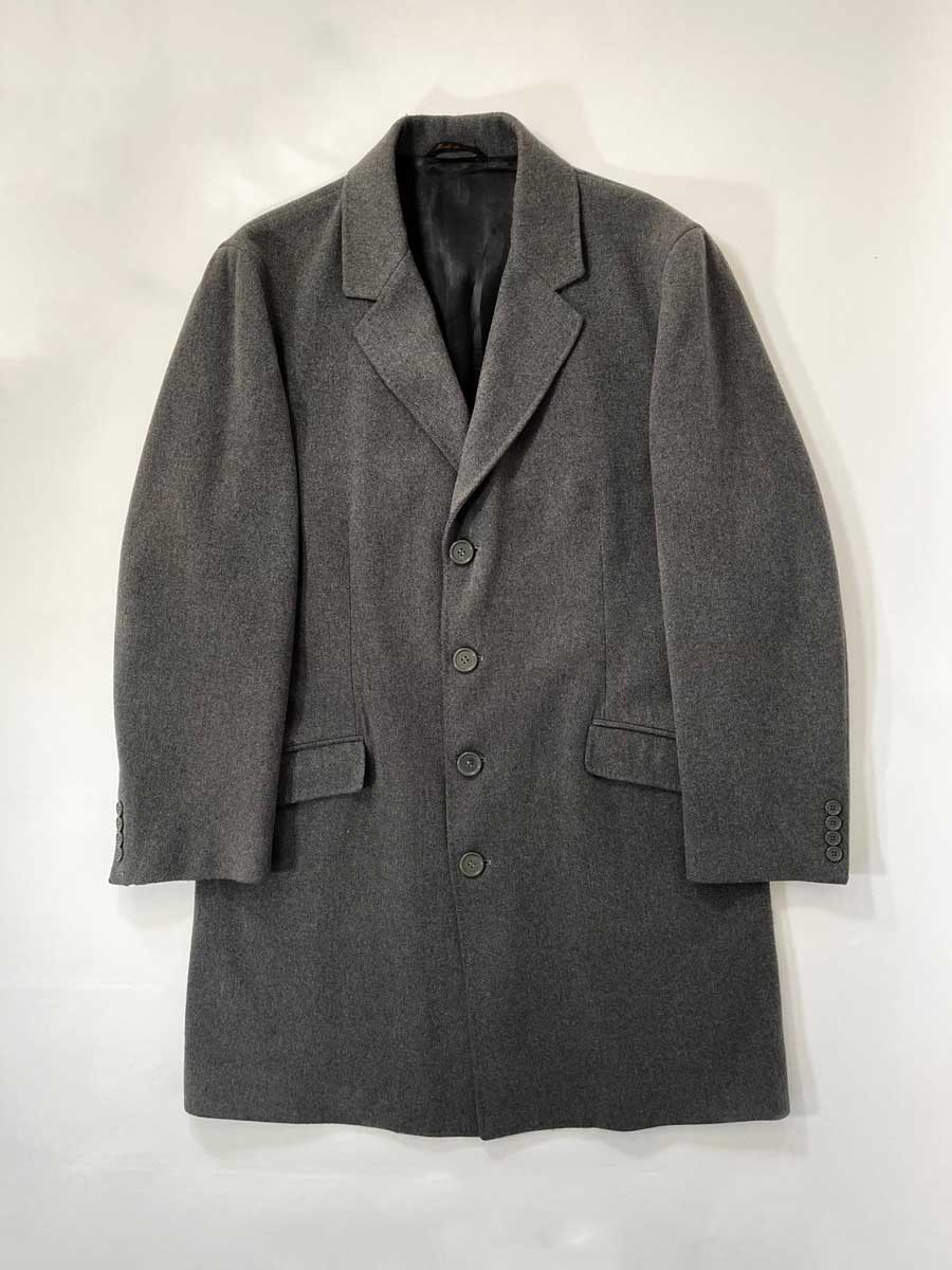 Elegant handcrafted vintage overcoat expertly made in Italy using traditional techniques and high quality materials. Color Melange Gray. Produced in 1990.