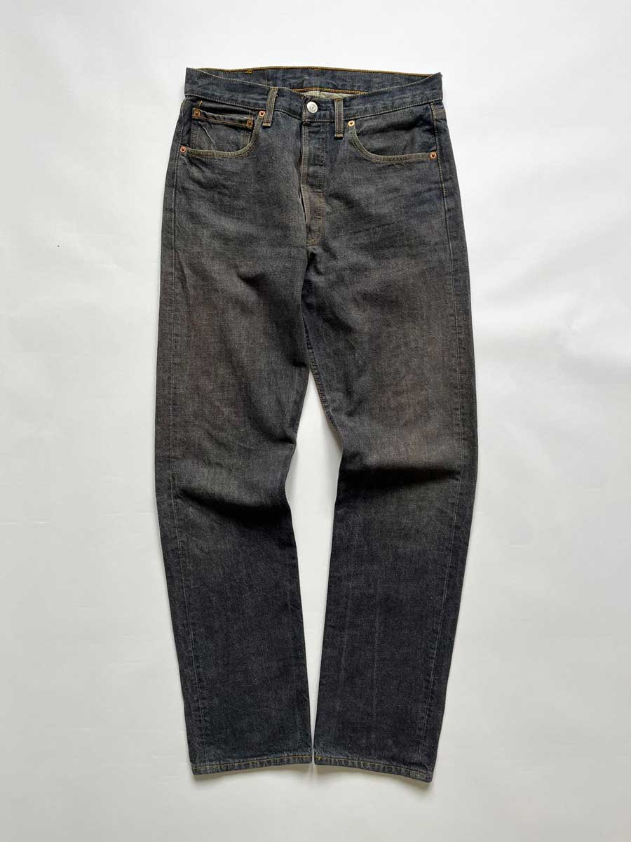 Jeans Levi's 501 vintage 90s raw, Placed on a neutral white background. Levi's vintage 501 raw from 1990s. Step into timeless style with this authentic vintage raw Levi's. Extreme quality fabric with unique color shades.