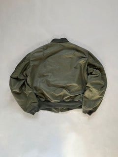 Back of the l2b bomber jacket, resting on a white surface