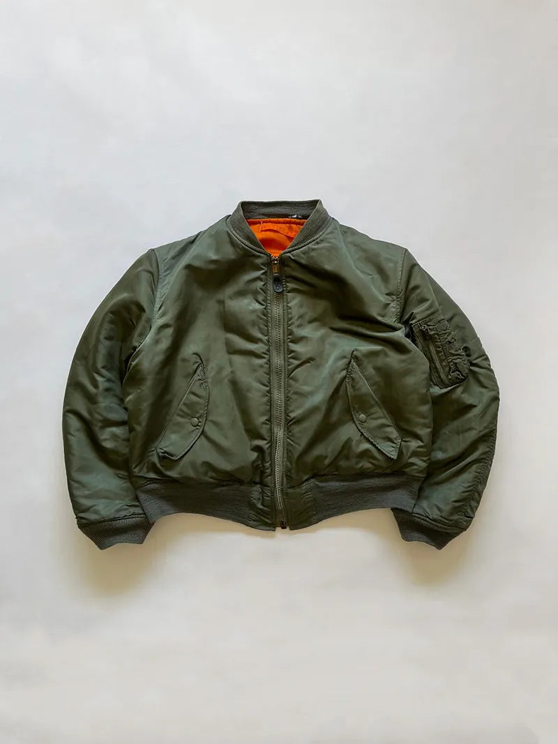Vintage Authentic US Air Force 1970's MA-1 bomber jacket, produced by Alpha Industries in 1973, with safety orange lining and fully reversible. Zip Scovill.
