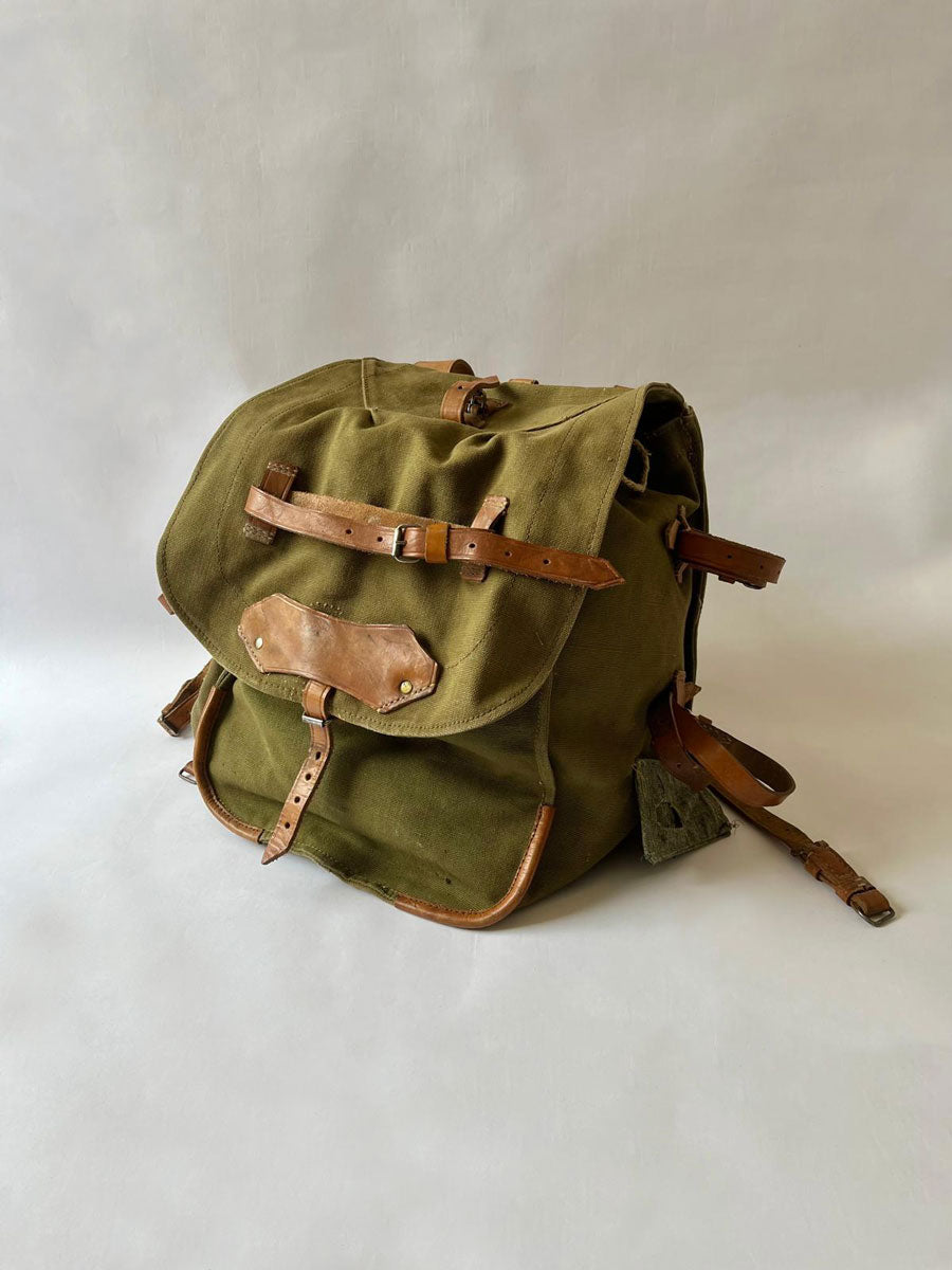 Vintage army backpack used by the Romanian army from the 1970s to the 1980s. This military canvas bag is constructed of leather and with unique details.