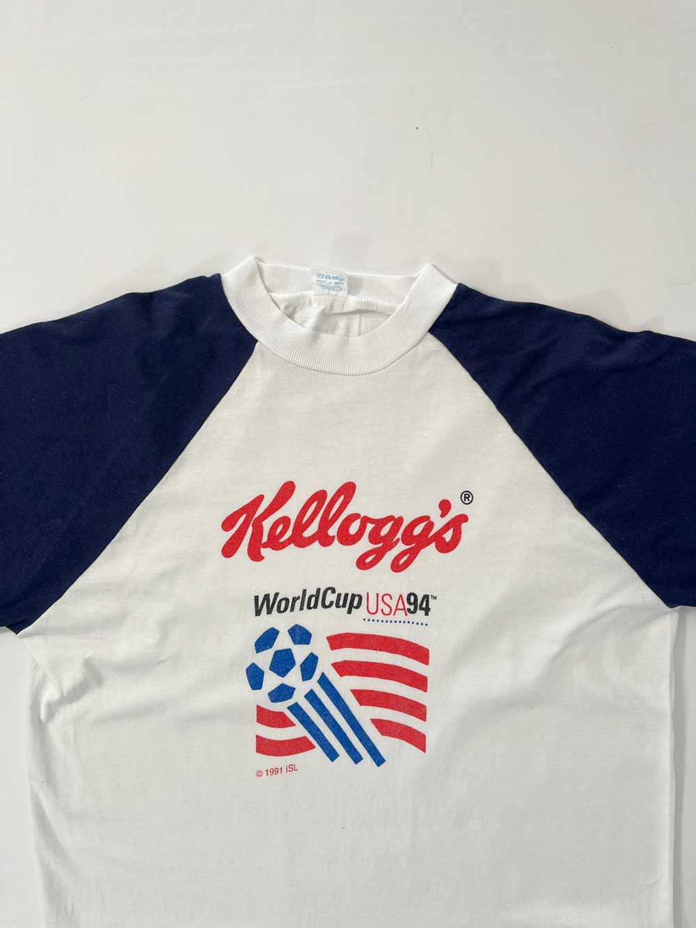 Vintage t-shirt created by Kellogg's for the USA94 World Cup. Kellogg's created, as did other major companies, shirts for the 1994 USA FIFA World Cup. Positioned on a neutral white background.