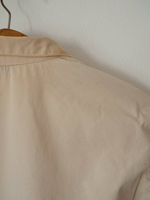 Close-up of the back collar and shoulder showing a small faint mark, part of the jacket's vintage condition.