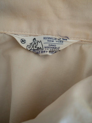 Interior label reading JEM Jackets, Rockville Centre, New York, with size M marked, inside the vintage Harrington jacket.