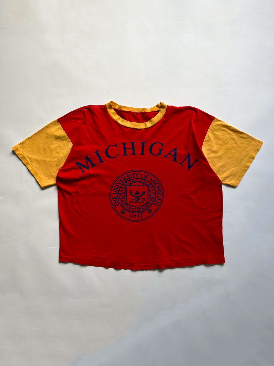 University of Michigan single stitch tee. Made in the United States in 1980. Bright red color with orange sleeves. Rare vintage piece. Quality cotton.