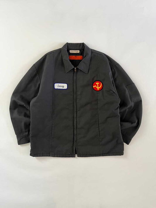 Vintage work jacket produced in the 1990s by Red Kap. Quality fabric and perfectly maintained over time. Talon zip and double patch applied on the front. Positioned on a neutral white background.