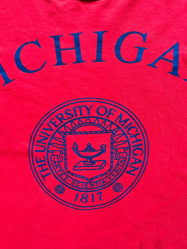 University of Michigan single stitch tee. Made in the United States in 1980. Bright red color with orange sleeves. Rare vintage piece. Quality cotton.