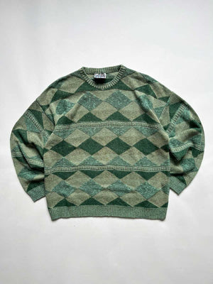 Green vintage sweater from the 90s. Wool fabric. Placed on a neutral white background.