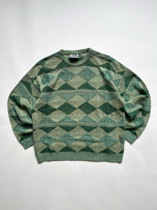 Green vintage sweater from the 90s. Wool fabric. Placed on a neutral white background.