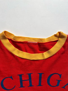 University of Michigan single stitch tee. Made in the United States in 1980. Bright red color with orange sleeves. Rare vintage piece. Quality cotton.