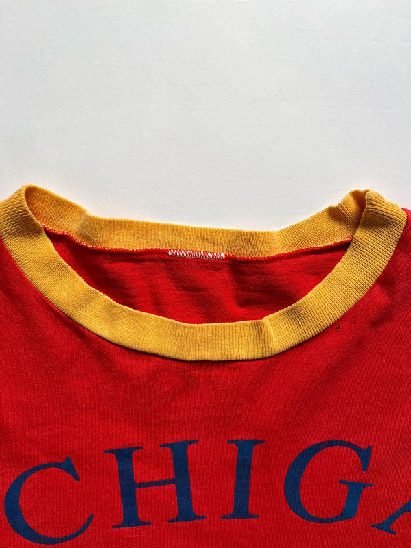 University of Michigan single stitch tee. Made in the United States in 1980. Bright red color with orange sleeves. Rare vintage piece. Quality cotton.