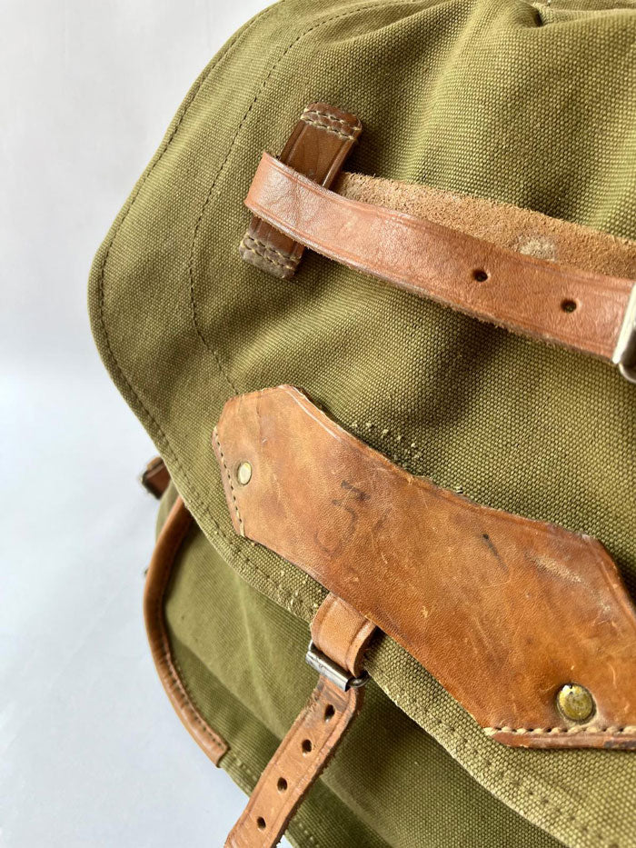 Vintage army backpack used by the Romanian army from the 1970s to the 1980s. This military canvas bag is constructed of leather and with unique details. 