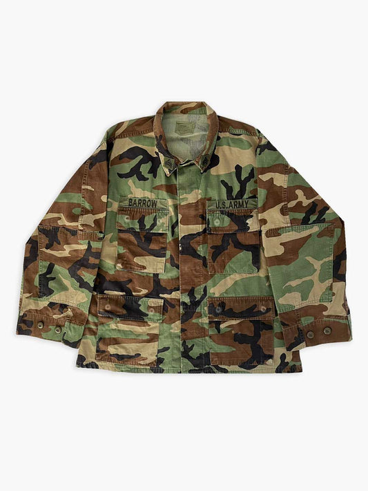 Vintage 90s US Army Warm Weather Woodland Camouflage Pattern Combat Coat, made of a tough and durable ripstop fabric. Made in the USA by EA Industries Inc. 