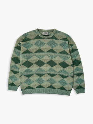 Green vintage sweater from the 90s. Wool fabric. Placed on a neutral white background.