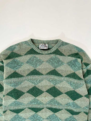 Green vintage sweater from the 90s. Wool fabric. Placed on a neutral white background.