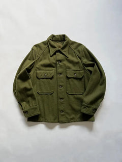OG 107 US Army wool shirt. Coming directly from the Korean War era. Size medium. Green color and boxy fit. American army surplus item. Made in USA.