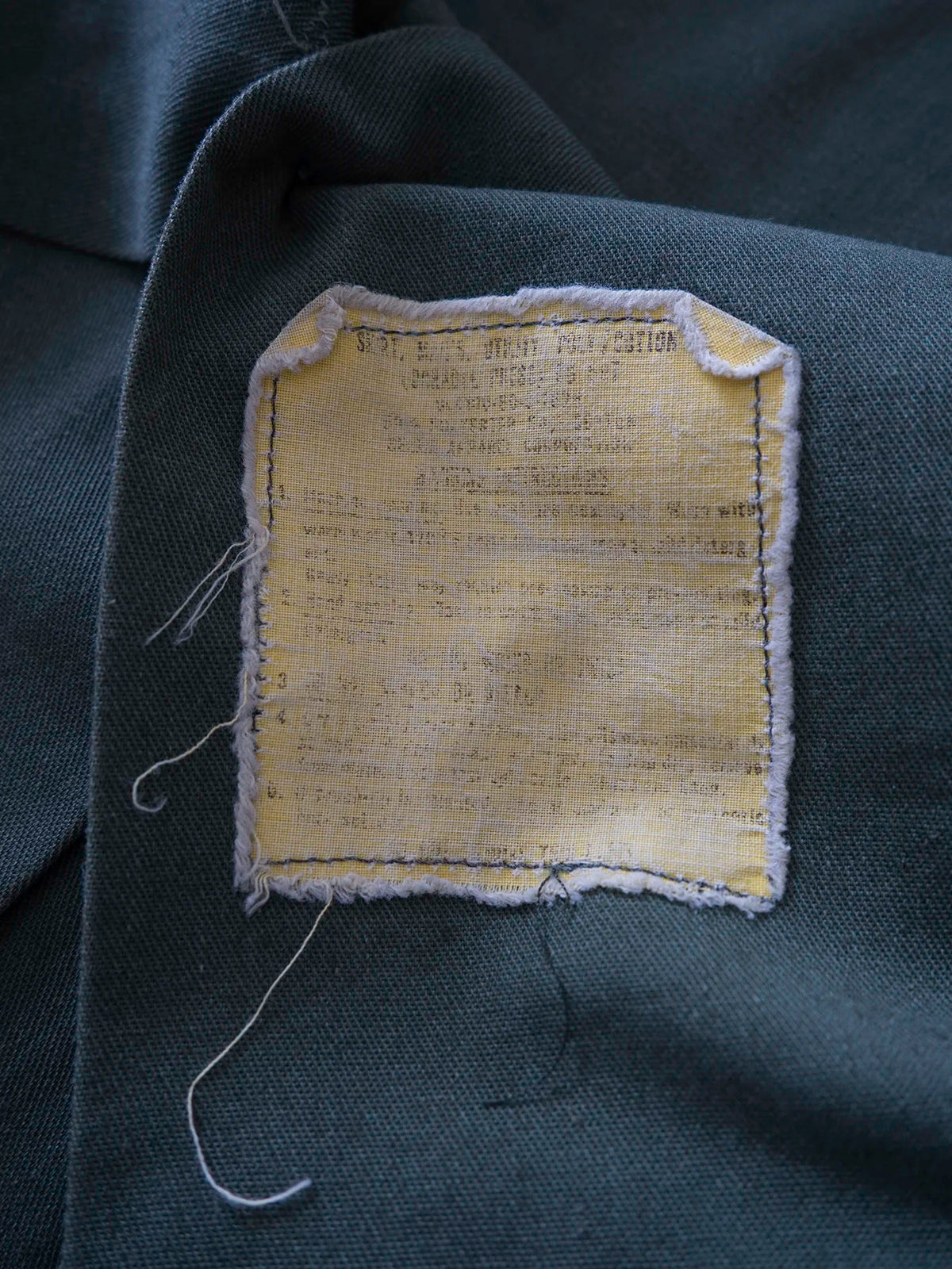 Detail of the original yellow durable press care label inside the OG-507 shirt.