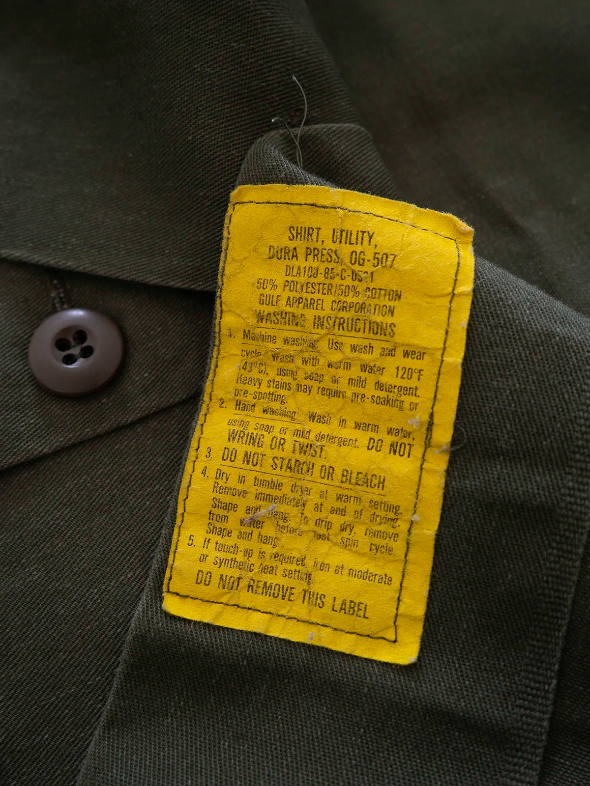 Back view of the OG-507 vintage US Army shirt in olive green cotton-polyester twill.