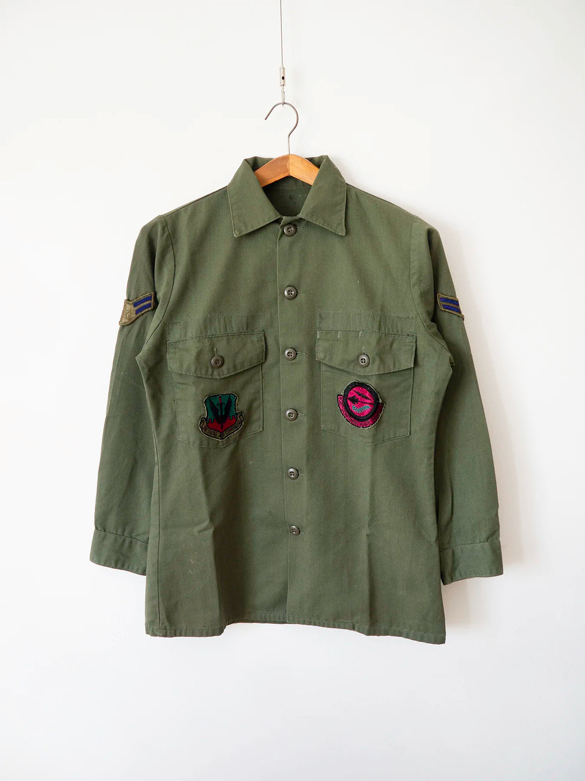 OG-507 vintage US Air Force utility shirt, size S, with two embroidered squadron patches on the chest pockets.