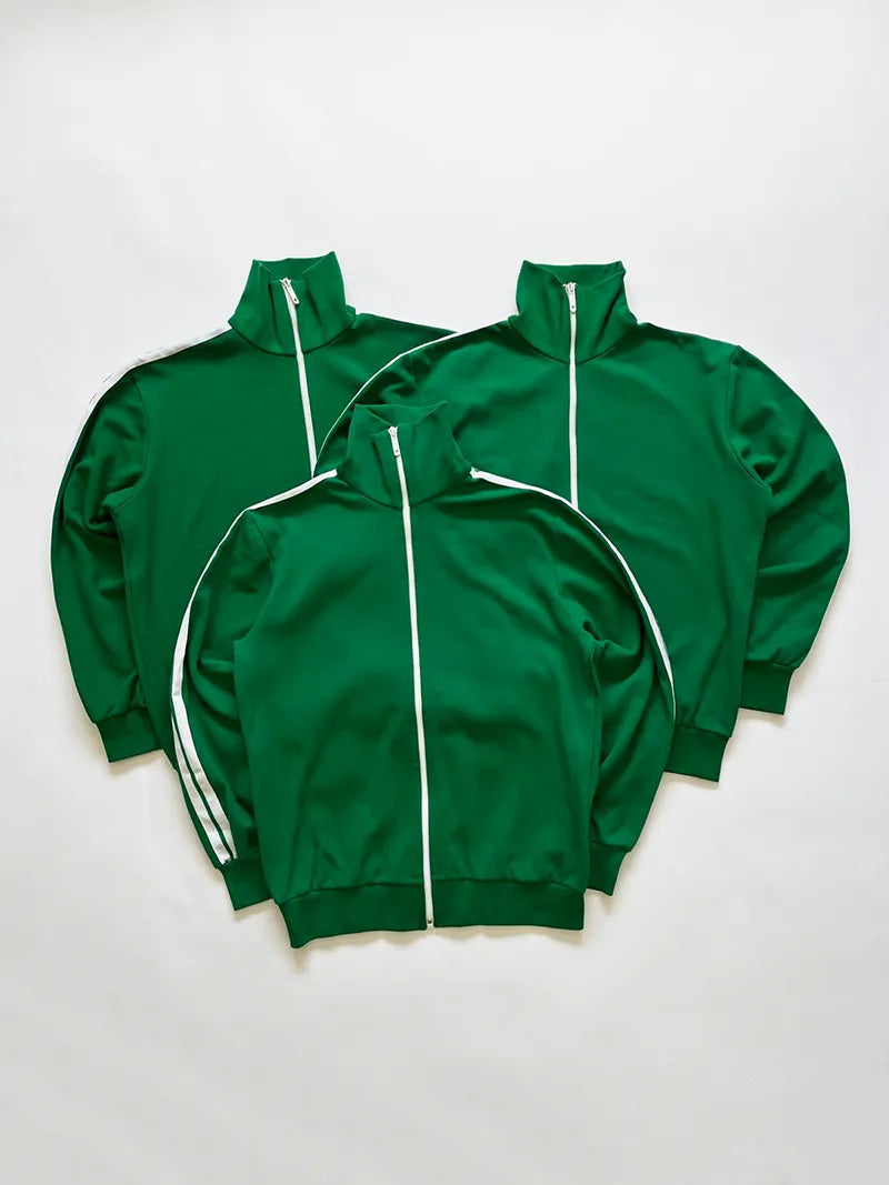 Vintage 1980s track jacket, part of an official German issue. The design features a green Opti front zip and two contrasting white stripes down the sleeves.