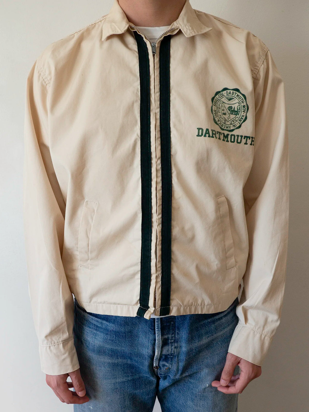 Vintage 1950s-60s Dartmouth College Harrington jacket worn open over jeans, showing the boxy fit and dark green zip trim.