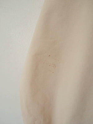 Close-up of the cotton fabric showing light surface marks, part of the jacket's visible wear as a vintage piece.