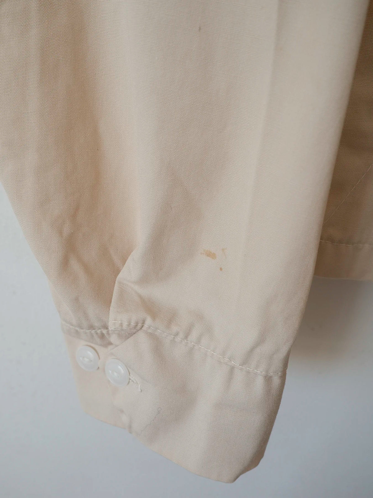 Close-up of the cuff hem showing a small faint stain, one of the minor flaws on this vintage Harrington jacket.