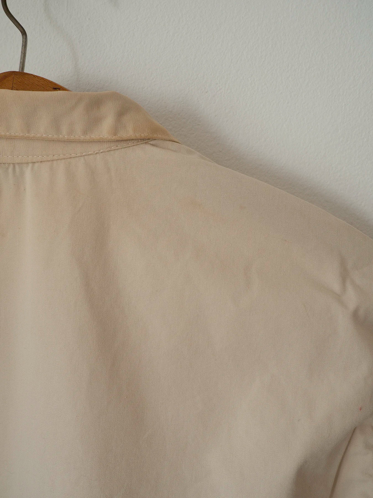 Close-up of the back collar and shoulder showing a small faint mark, part of the jacket's vintage condition.