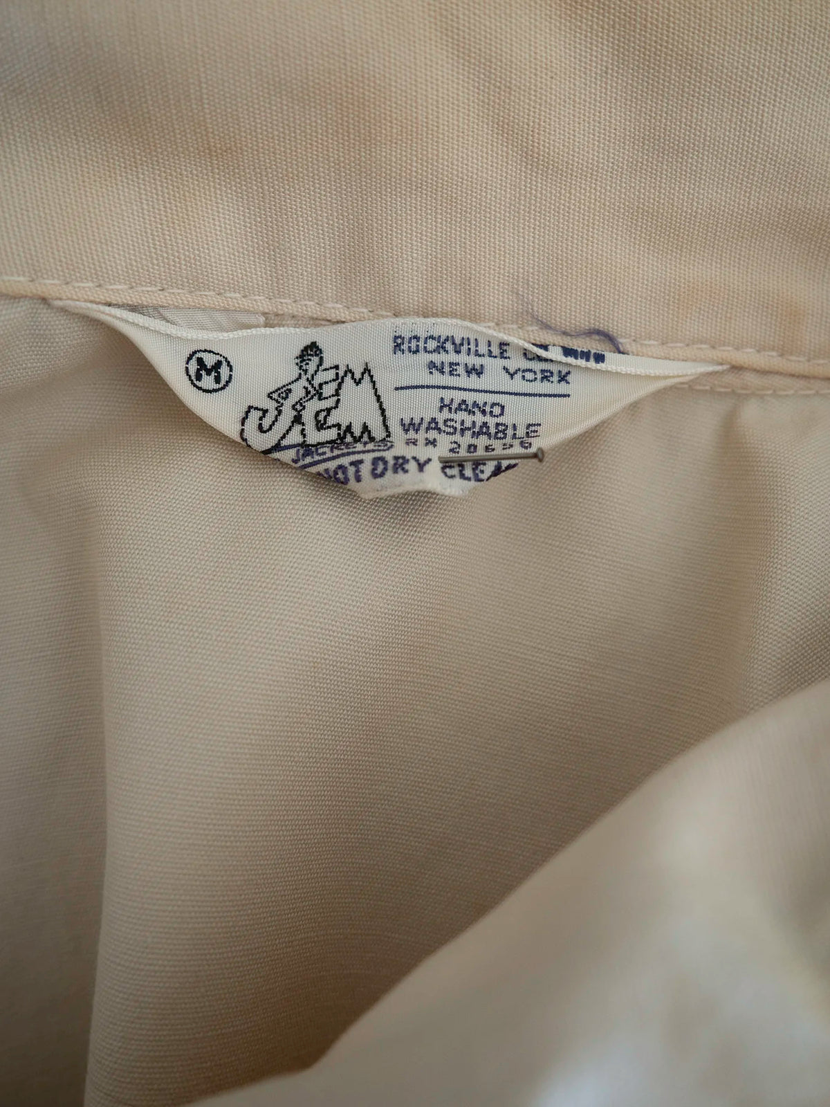 Interior label reading JEM Jackets, Rockville Centre, New York, with size M marked, inside the vintage Harrington jacket.